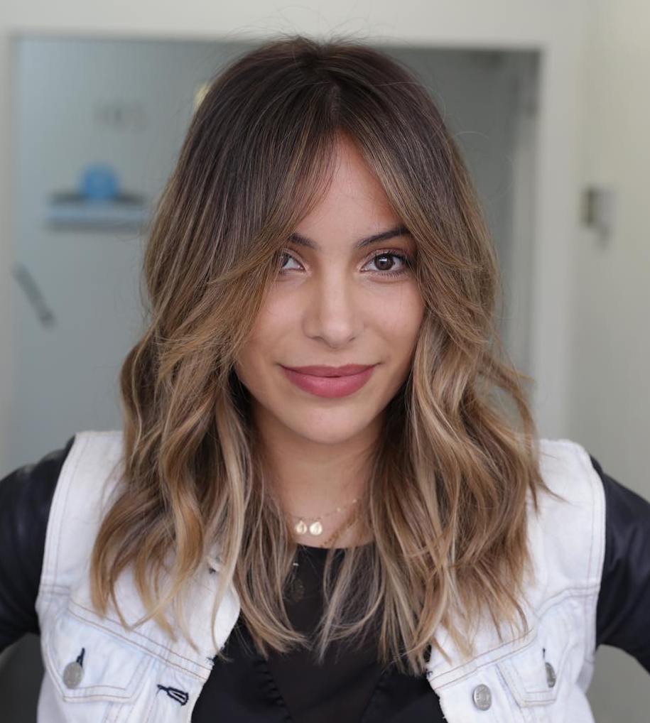 Mid-Length Wavy Hair With A Split Fringe